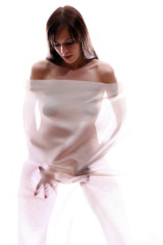 The body of a beautiful naked woman through the transparent fabric on a white background