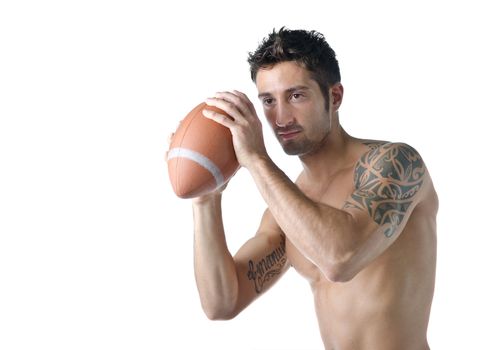 Attractive, fit, shirtless young man holding american football ball, isolated on white