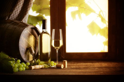 Wine bottle and wineglass on wooden table,