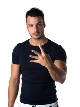 Attractive young man counting to four with fingers and hands, isolated on white background