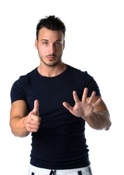 Attractive young man counting to six with fingers and hands, isolated on white background