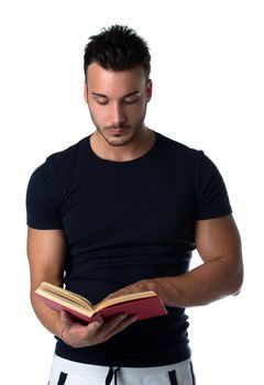 Handsome and athletic young man reading book, isolated on white background