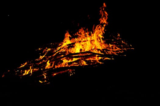 red flames of huge bonfire or campfire as black backgorund