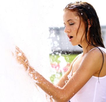 Young happy woman wet in the rain