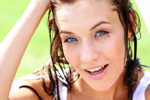 Young happy woman wet in the rain