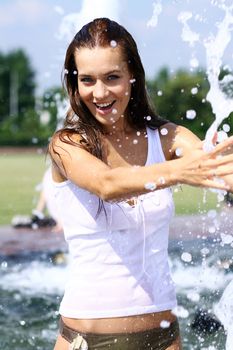 Young happy woman wet in the rain