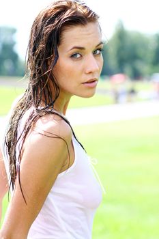 Young happy woman wet in the rain