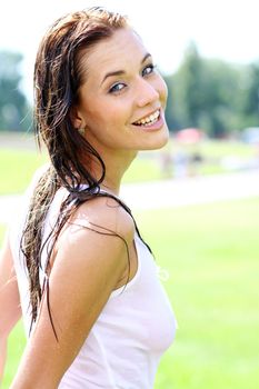 Young happy woman wet in the rain
