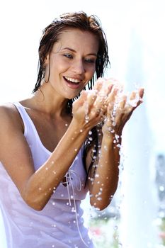 Young happy woman wet in the rain