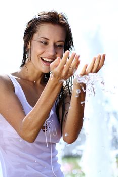 Young happy woman wet in the rain
