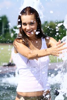 Young happy woman wet in the rain