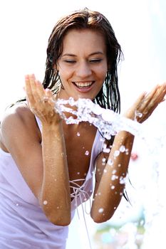 Young happy woman wet in the rain