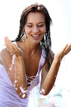 Young happy woman wet in the rain