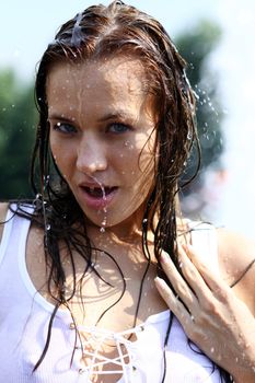 Young happy woman wet in the rain