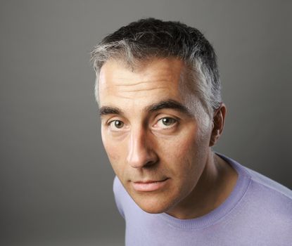 Portrait of casual man on grey background