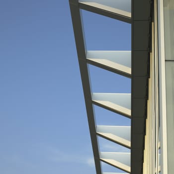 Modern architectural building awning against blue sky