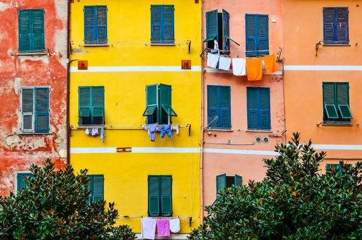 Detail of colorful house walls, windows and drying clothes, Cinque Terre, Italy