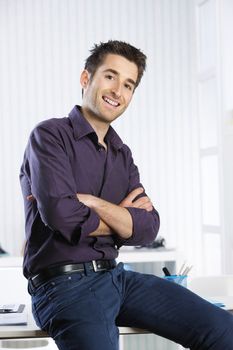Portrait of a smiling young man in his office