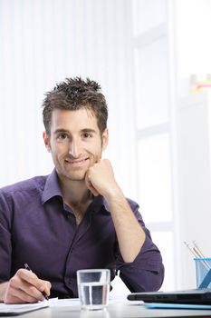 Portrait of a young man working at desk