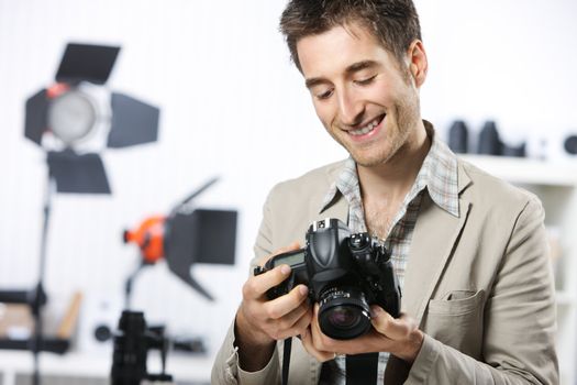 Portrait of happy photographer with professional digital camera