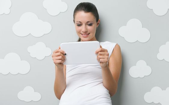 A beautiful young woman working on her digital touchpad 