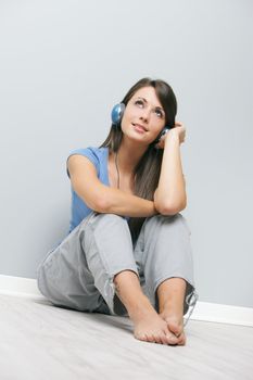 A young lady enjoying music through her headphones 