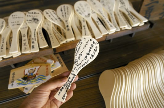 Japanese prayer spoons at Itsukushima Shrine. Itsukushima is an island in the western part of the Inland Sea of Japan, located in the northwest of Hiroshima Bay. It is popularly known as Miyajima, (The Shrine Island). Itsukushima Shrine is a UNESCO World Heritage Site.