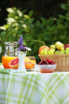 Close up of a table with fruit and orange juice