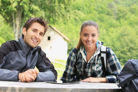 Portrait of happy hikers couple resting outdoors