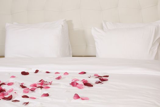 hotel room with big bed and red flowers