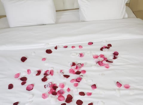 hotel room with big bed and red flowers