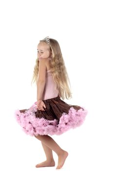 Shot of little dancing girl with long blond hair in studio