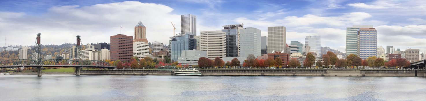 Portland Oregon Downtown City Waterfront Skyline Along Willamette River with Blue Sky and White Clouds in Fall Season Panorama