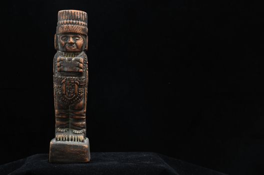 One Ancient Mayan Statue on a Black Background