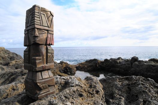 Ancient Maya Statue on the Rocks near the Ocean