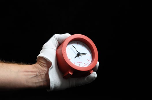 Clock And an Hand on a Black Background