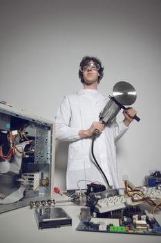 Bizarre computer technician with a circular saw
