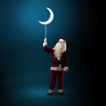 Santa Claus holding a string of luminous glowing moon