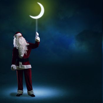 Santa Claus holding a string of luminous glowing moon