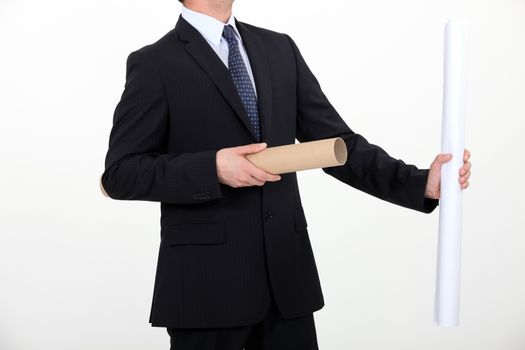 Businessman taking a rolled up plan out of its case