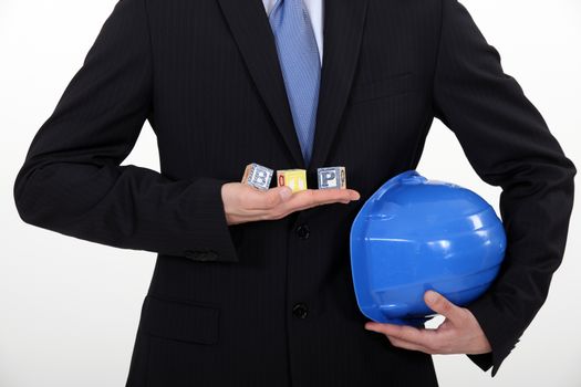 Architect holding toy building blocks