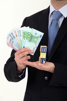 Businessman holding cash and the letters BTP