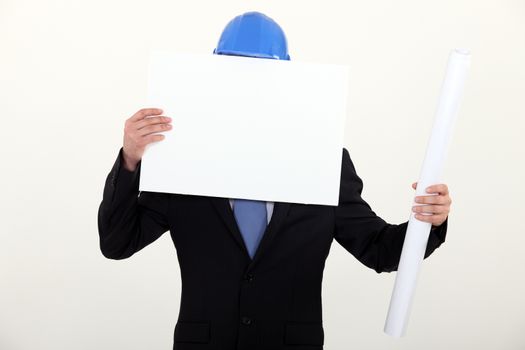 Man with helmet covered with white poster