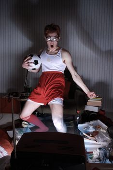 Nerd boy excited by goal scored during sports competition