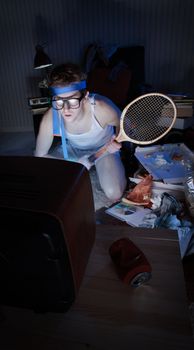 Young man tennis fanatic getting really into the tennis game on television