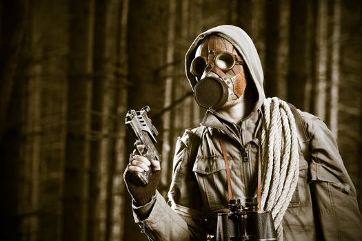 Soldier wearing a gas mask is fighting in a forest