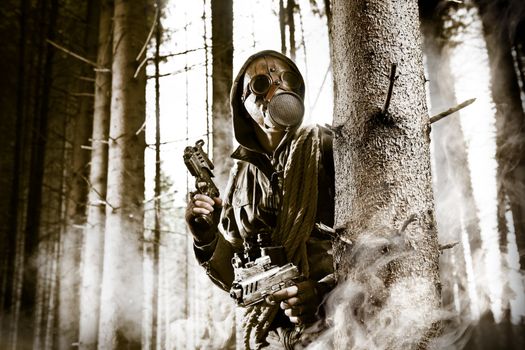 A soldier wearing gas mask is fighting in the forest