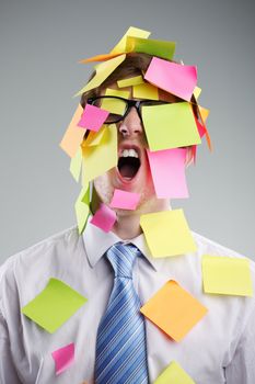 Office worker with post-its all over his face