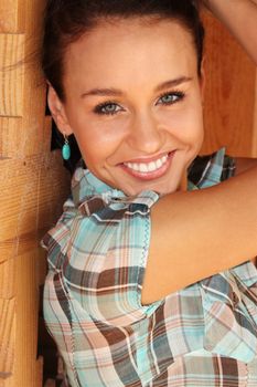 Young happy woman in cell shirt