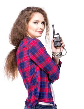 Attractive young woman in a checkered shirt with walkie talkie, isolated